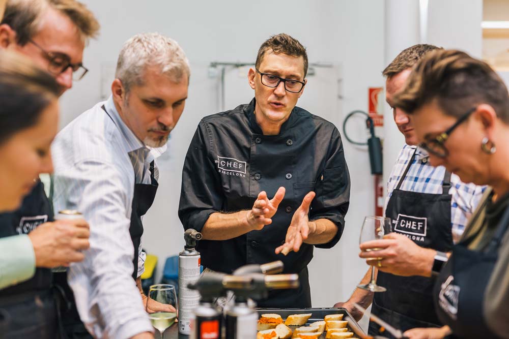 explaining how to make tapas in our tapas team competition in barcelona